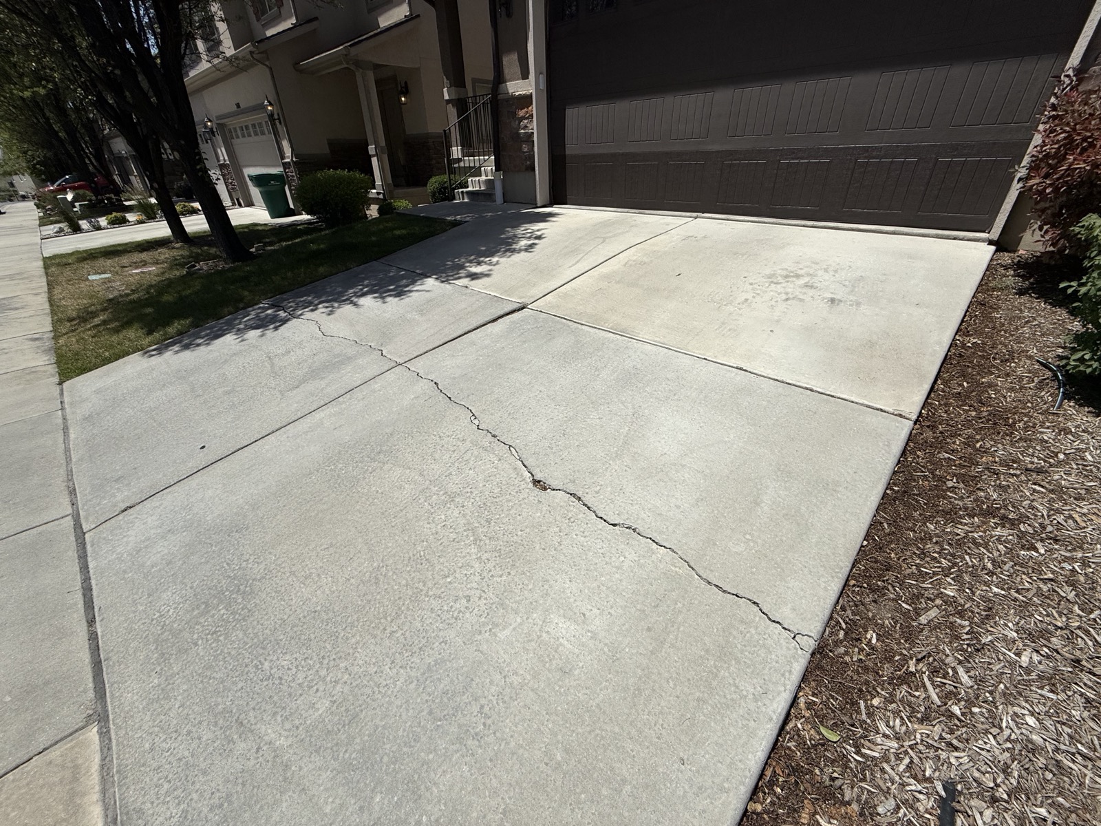 Cracked, settled driveway before lifting, Lehi